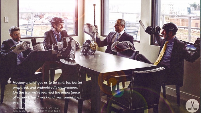 Five Skyline owners sit at a table in suits. Each of them also has on some form of hockey equipment. The caption in the photo is, 