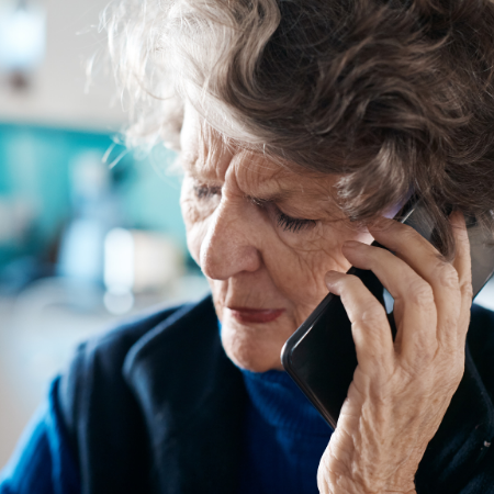 Woman looking concerned on cell phone.